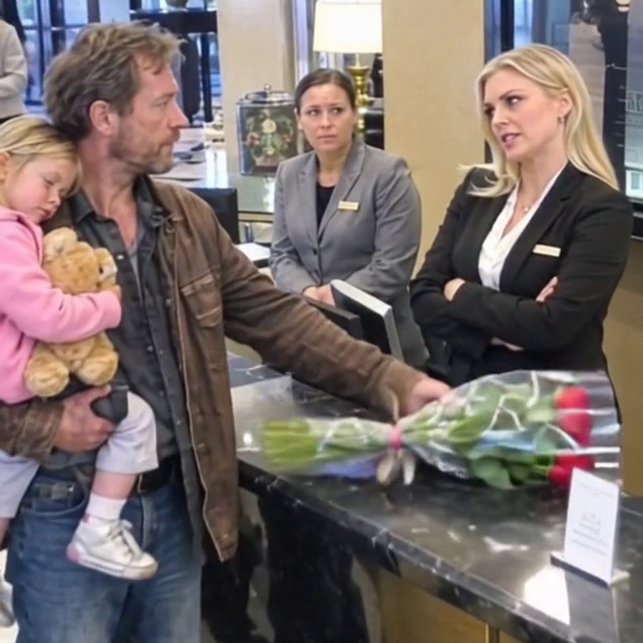 A widowed father carrying his sleeping daughter was turned away from the very hotel he