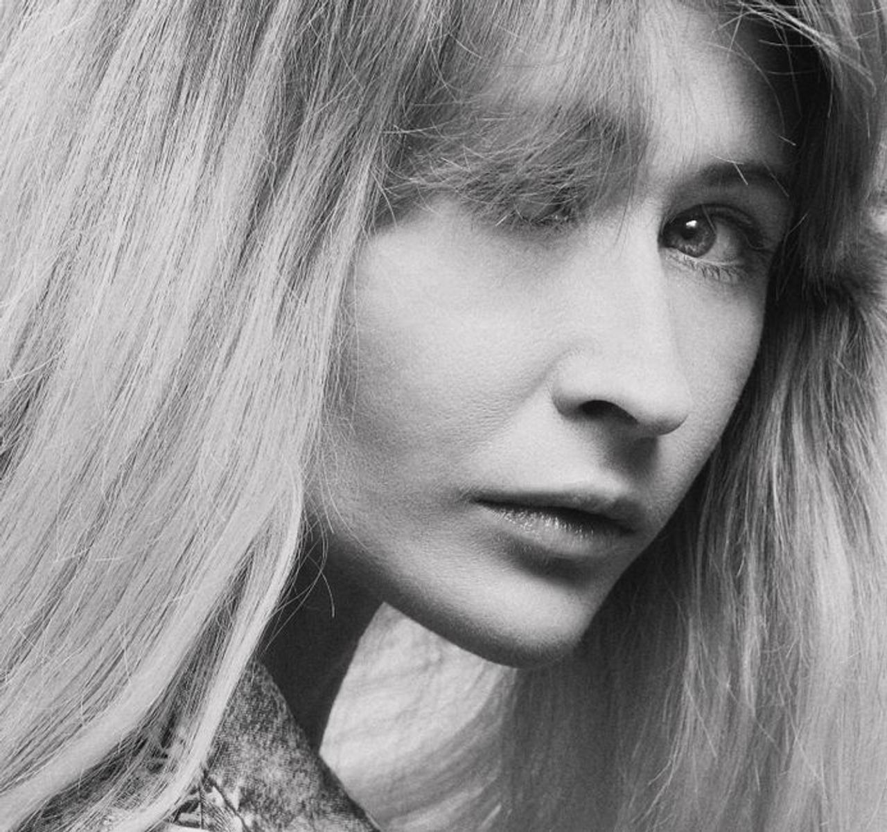 Close-up black and white portrait showcasing a woman's expressive gaze.